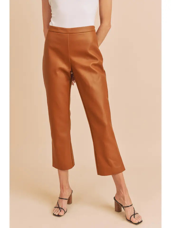 Camel vegan leather cropped dress pants styled with a white sleeveless top and strappy heels