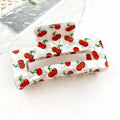 Hollow Square Cherry Print Claw Clip in pearlescent white acetate with all-over red cherry and green stem print
