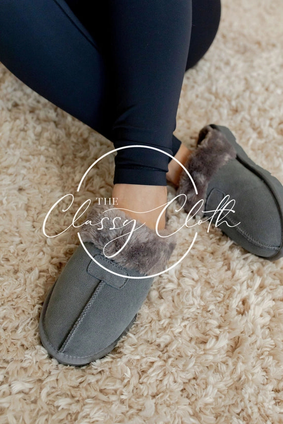 Grey slip-on slippers with fluffy grey cuffs, rounded toes, and visible center seams