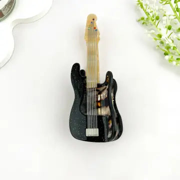Guitar-shaped claw clip in black and tortoiseshell with silver string detail