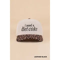 Light corduroy hat with black i need a diet coke lettering and a leopard-print curved brim