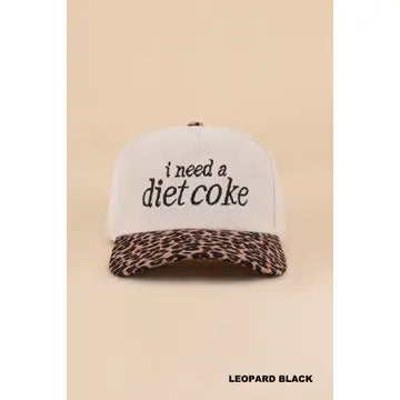Light corduroy hat with black i need a diet coke lettering and a leopard-print curved brim