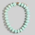 Chunky pale mint-green jade rondelle bead necklace with small matching spacers and a gold-tone clasp and extender chain