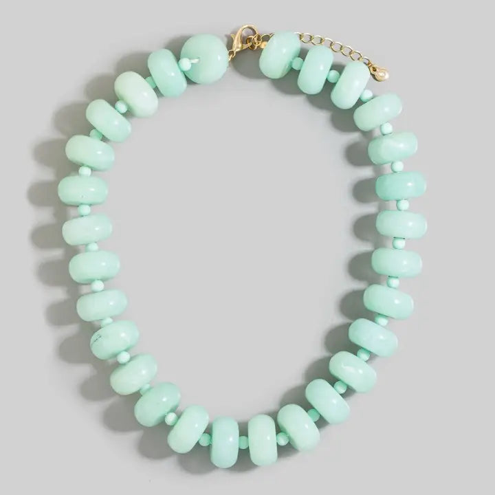 Chunky pale mint-green jade rondelle bead necklace with small matching spacers and a gold-tone clasp and extender chain