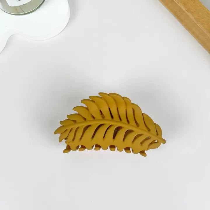 Golden Leaf Claw Clip in matte mustard gold with fern leaf silhouette and open cutout detailing