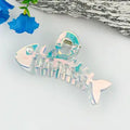 Pearl fishbone claw clip in translucent iridescent pearlescent finish with aqua and pink shimmer