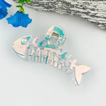 Pearl fishbone claw clip in translucent iridescent pearlescent finish with aqua and pink shimmer
