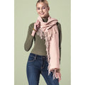 Model wearing a muted rose scarf with fringe detailing over an olive top