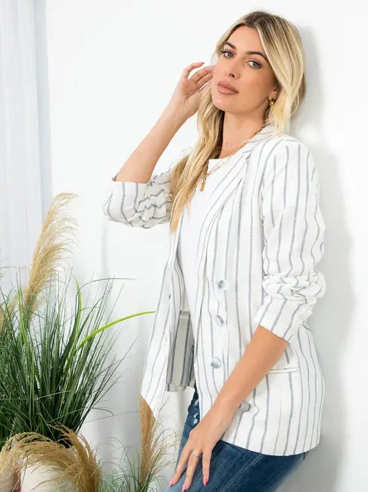 Light-colored open-front sailor blazer with contrasting vertical stripes, notched lapels, and front pocket details