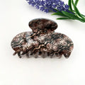 Snake Print Claw Clip in oversized acetate with smoky brown, taupe, and grey python snake skin texture print