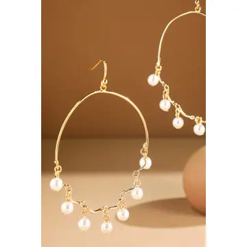 Gold-tone open teardrop earrings with dangling white pearl charms and hook closures