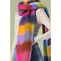 Model wearing a colorful checkered scarf in pink, purple, blue, green, and yellow