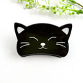 Black Cat Claw Clip in glossy black with white engraved whiskers and sleepy eye details
