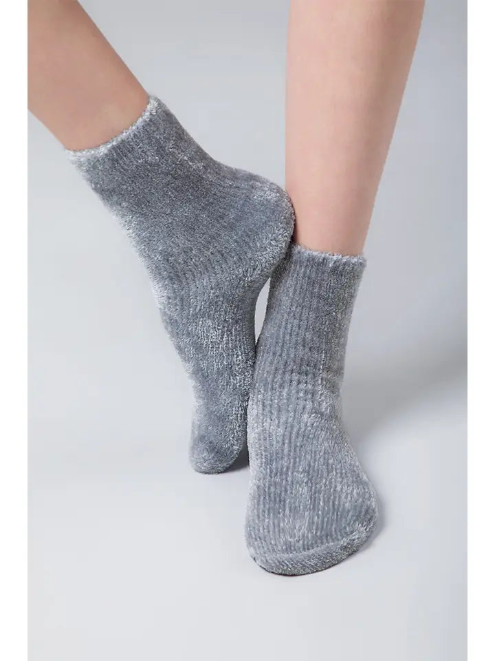 Cozy grey chenille socks with subtle shimmer worn on a neutral background