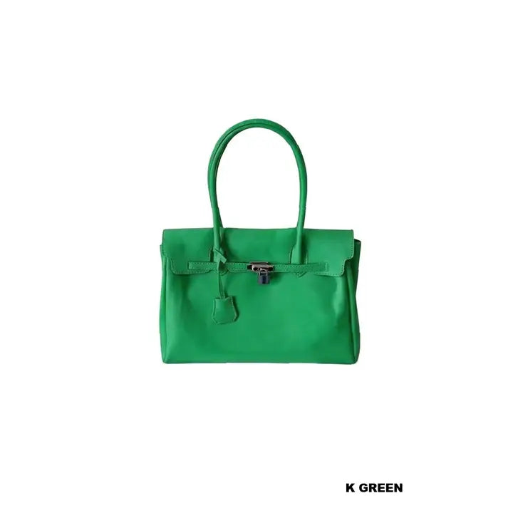 Kelly green jelly firkin bag with dual top handles and silver lock clasp detail on white background