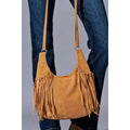 Camel faux-suede slouchy shoulder bag with long side fringe and a single strap