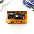 Vintage Cassette Claw Clip shaped like a retro cassette tape in warm gold chrome acetate with printed RELAX label, 60 MIN, reel windows, and red K badge