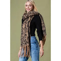 Model wearing a brown and tan leopard print scarf with long fringed ends