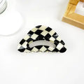 Vintage Checkered Claw Clip in bold black and cream diamond checkerboard acetate with curved arch hollow silhouette
