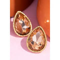 Faceted peach-colored teardrop stud earrings with textured gold-tone borders