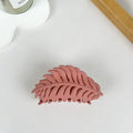 Pink Leaf Claw Clip in matte dusty rose with fern leaf silhouette and open cutout detailing