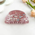 Purple Rhinestone Glitter Claw Clip in dusty mauve-purple translucent acetate encrusted with scattered rose pink and aurora borealis rhinestones