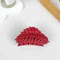 Red Leaf Claw Clip in matte cranberry red with fern leaf silhouette and open cutout detailing