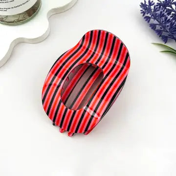 Red Striped Flat Claw Clip in glossy acetate with bold red and black vertical stripes on flat oval silhouette with hollow center