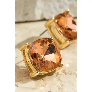 Faceted rose-colored acrylic stud earrings in gold-tone settings