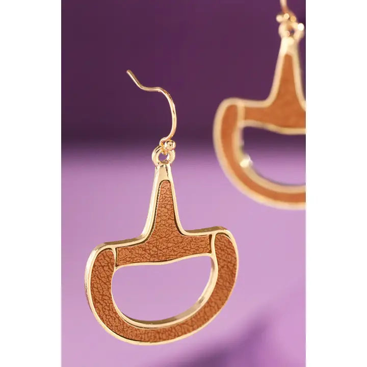 Faux leather and gold horse bit drop earrings on purple background