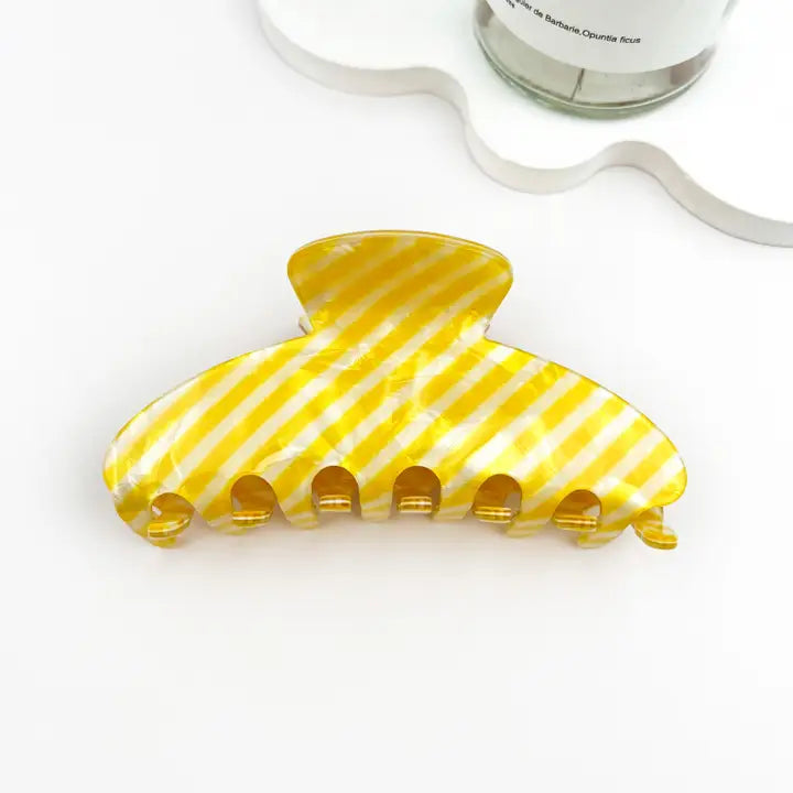 Yellow Striped Claw Clip in bright lemon yellow and white diagonal stripe glossy acetate with classic oversized claw silhouette