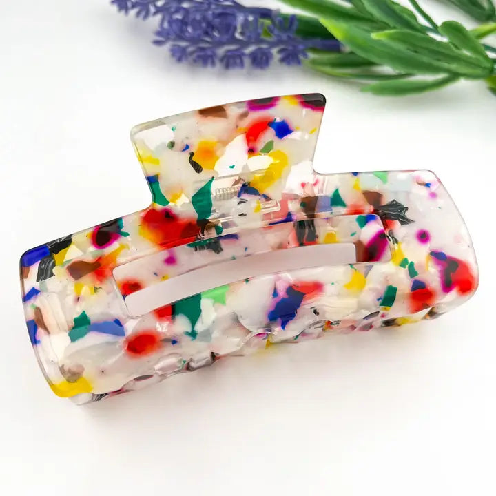 Colorful Geometric Hollow Square Claw Clip in confetti acetate with multicolor red, yellow, blue, green, and teal splashes on translucent white base