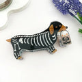 Skeleton Dog Claw Clip featuring a dachshund in a skeleton costume holding a ghost jack-o-lantern trick-or-treat bucket