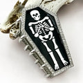 Rhinestone Skeleton Claw Clip in black with white skeleton graphic and full rhinestone border on silver hardware