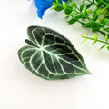 Green Monstera Claw Clip shaped like a heart-leaf anthurium in deep forest green with raised white vein detailing and glossy finish